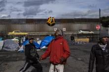 En las afueras de la Ciudad Deportiva Benito Juárez, un migrante hondureños juega al fútbol. La lluvia destrozó por completo el albergue de la colonia Benito Juárez en la ciudad de Tijuana. La calle era el nuevo ahogar de las familias que decidieron montar sus tiendas a unos cuantos metros del muro fronterizo de Estados Unidos.